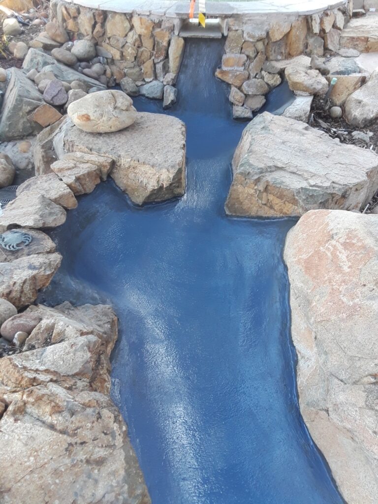 Pool waterfall cleaned, prepped and coated with waterproofing